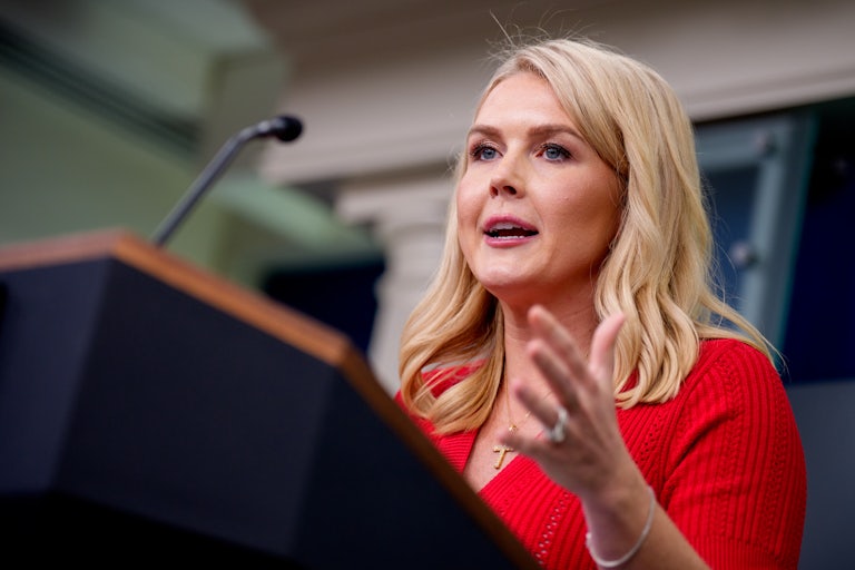 Press Secretary Karoline Leavitt gestures while speaking at the podium during a White House press briefing
