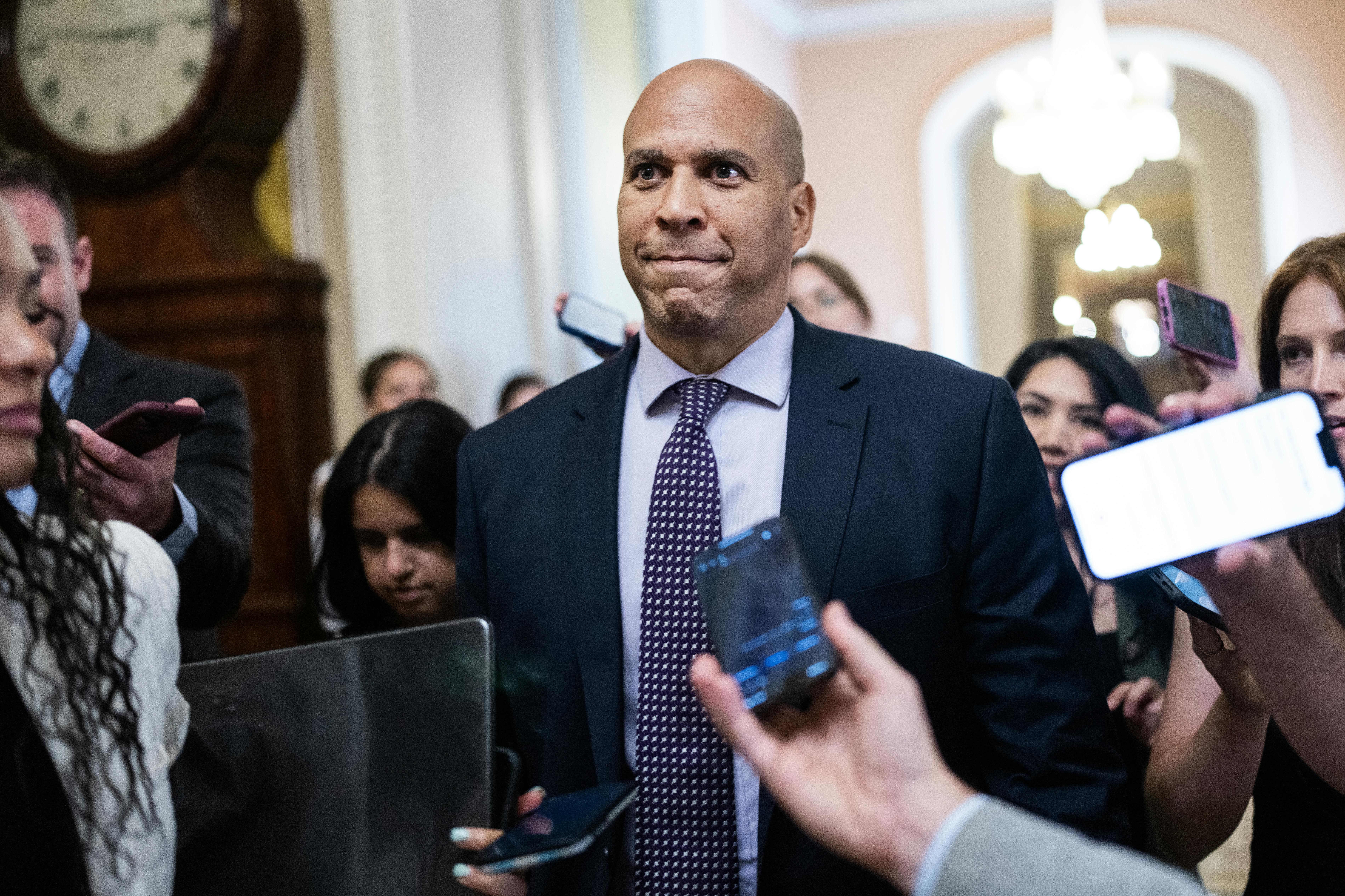 Cory Booker surrounded by reporters.