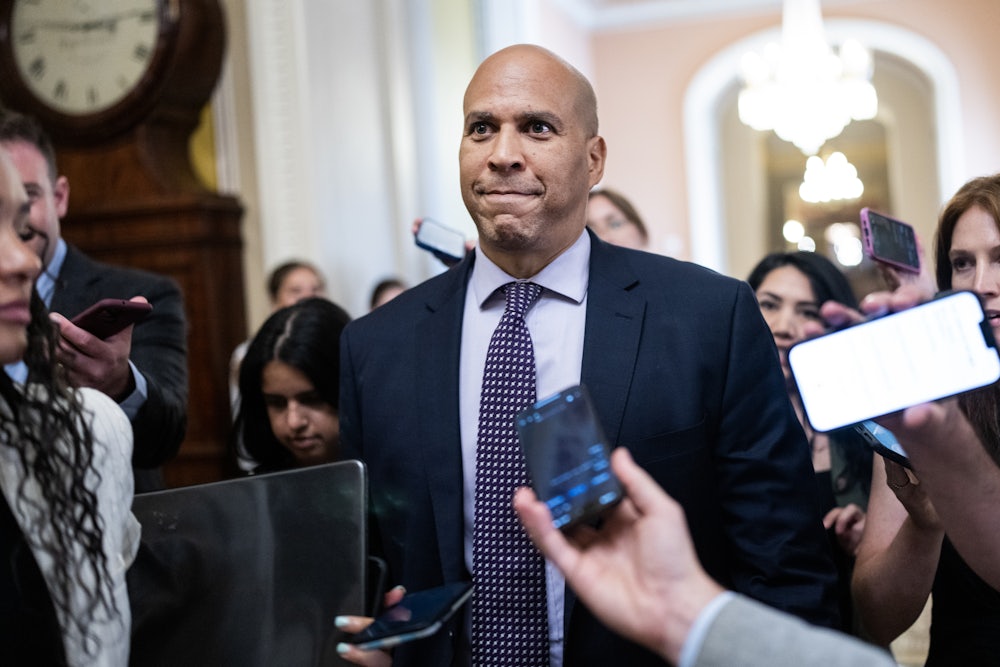Cory Booker surrounded by reporters.