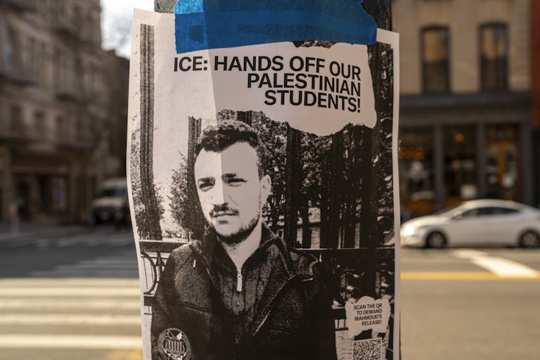A poster taped to a lamppost reads "ICE: HANDS OFF OUR PALESTINIAN STUDENTS!" with a picture of arrested Columbia University graduate Mahmoud Khalil.