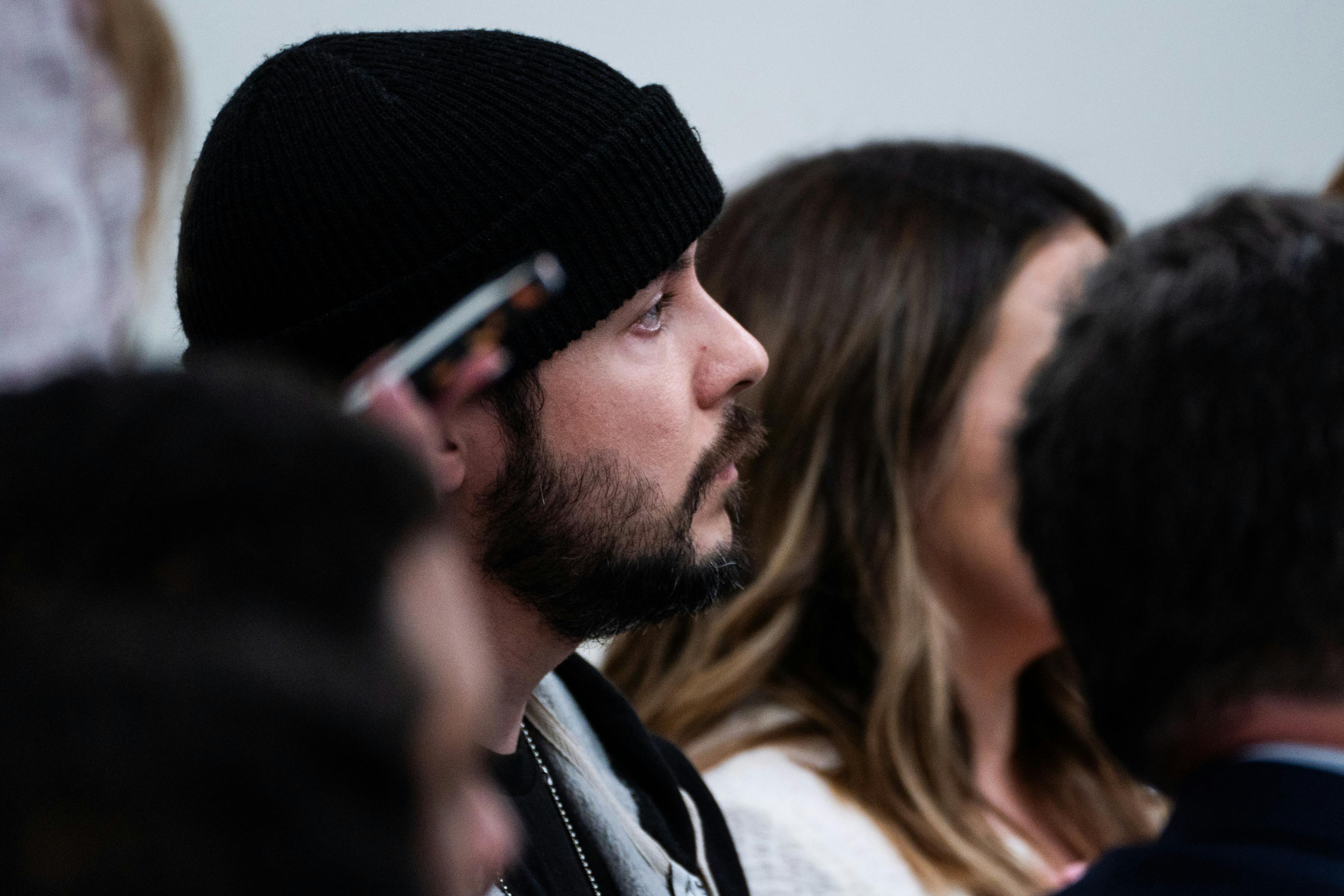 Far-right commentator Tim Pool is seen in profile as he sits in a White House press briefing
