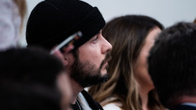 Far-right commentator Tim Pool is seen in profile as he sits in a White House press briefing
