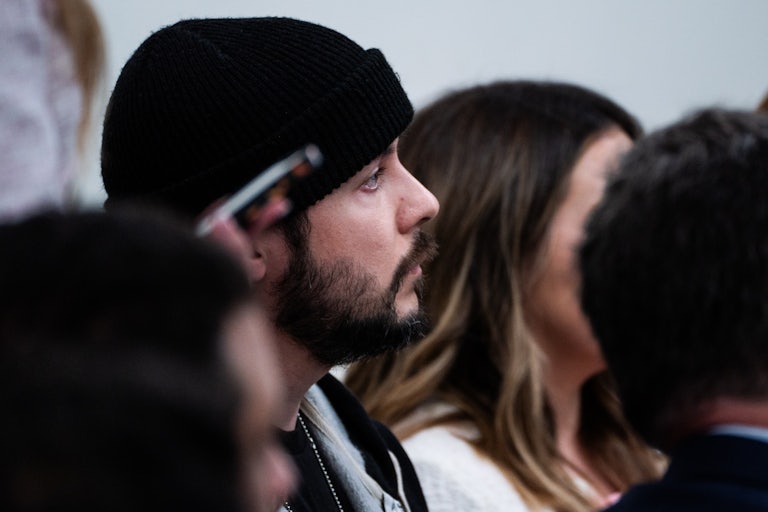 Far-right commentator Tim Pool is seen in profile as he sits in a White House press briefing