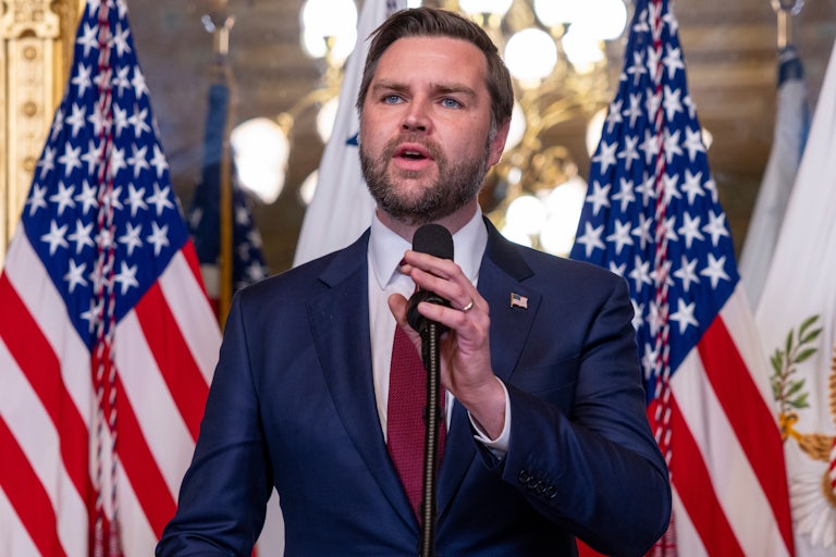 JD Vance gestures while speaking at a podium