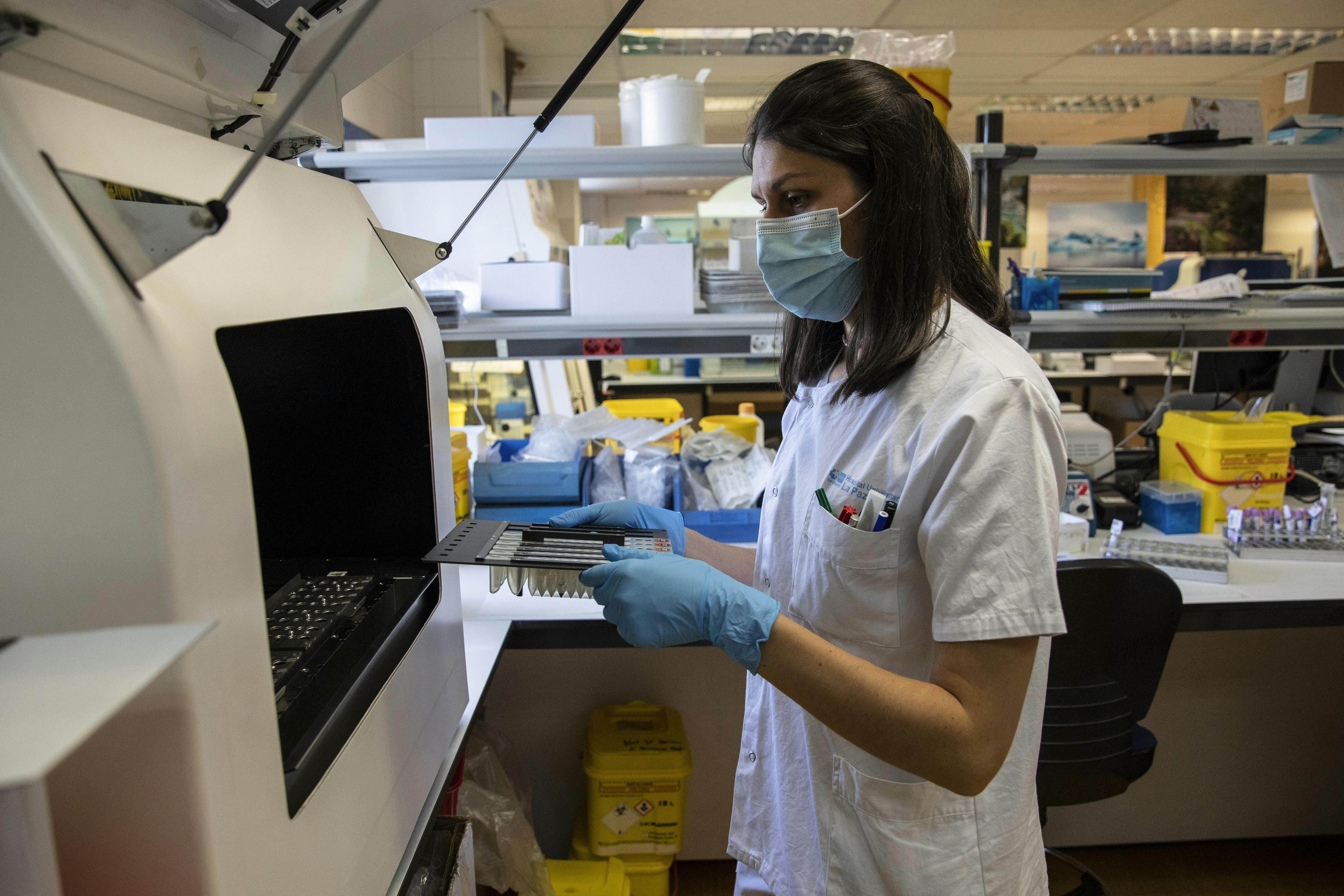 A laboratory technician holds samples for testing.