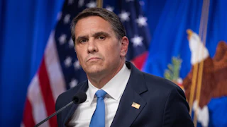 Acting Attorney General Todd Blanche stands at a podium