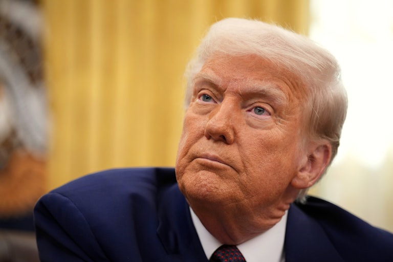 Donald Trump makes a weird face while seated in the Oval Office.