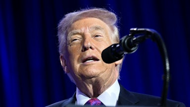 Donald Trump speaks into a mic.