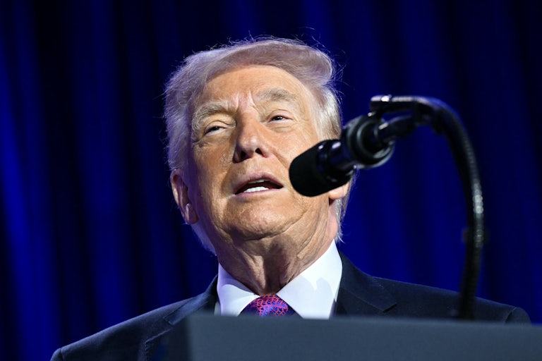 Donald Trump speaks into a mic.