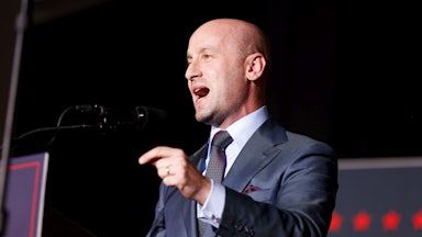 Stephen Miller yells at a lectern.