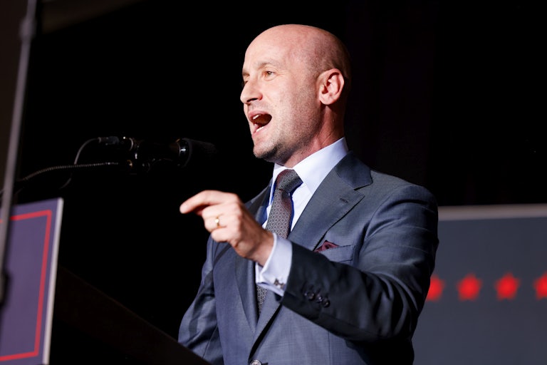 Stephen Miller yells at a lectern.