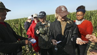 Teenagers hand around Band-Aids.