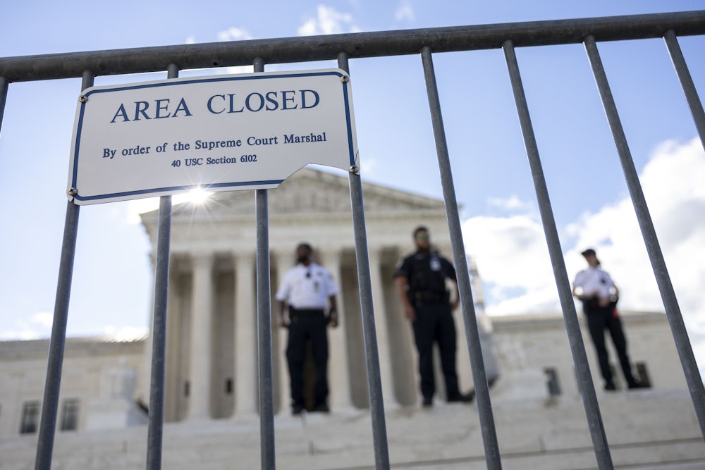 Police officers stand inside of a barricade at the Supreme Court of the United States in Washington, D.C.