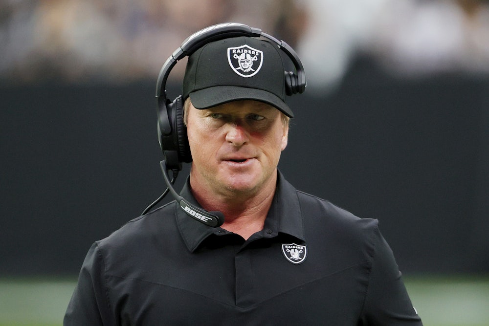 A close-up of a smirking Las Vegas Raiders coach Jon Gruden.