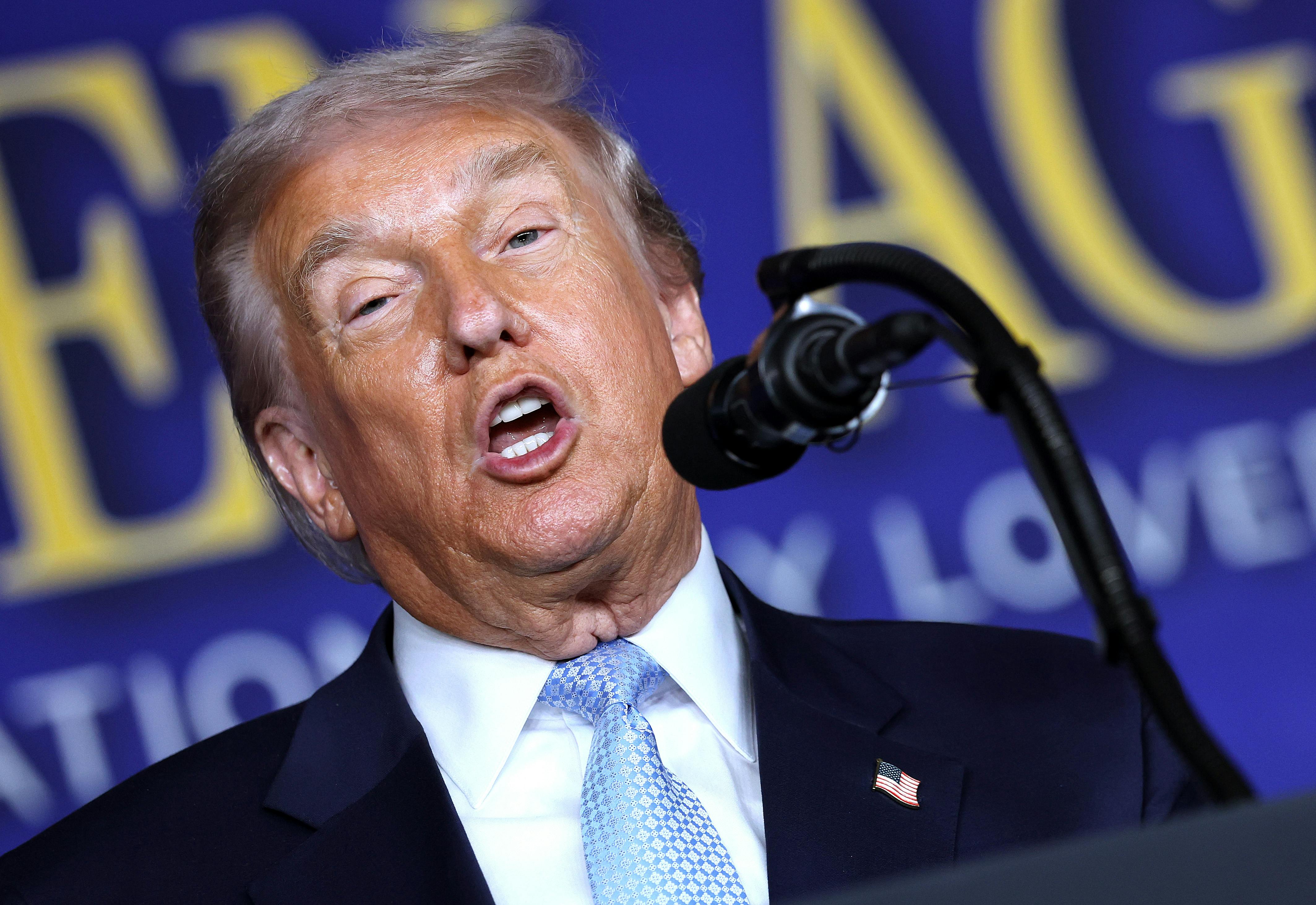 Donald Trump speaks into a microphone