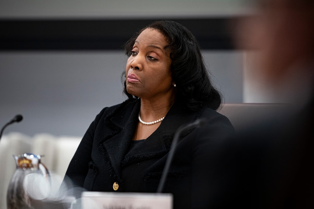 Federal Reserve Governor Lisa Cook sits in a Fed board meeting