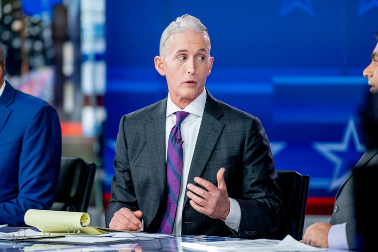 Fox News host Trey Gowdy speaks to others on set