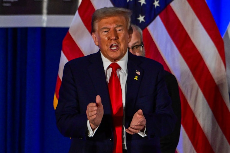 Donald Trump claps and speaks