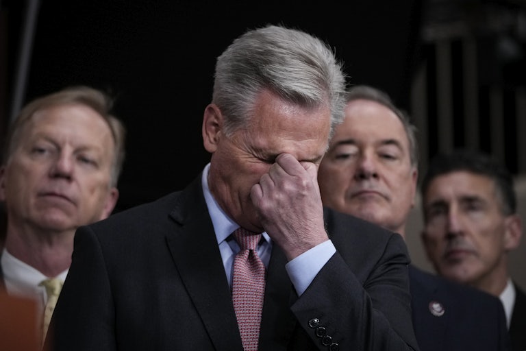 Representative Kevin McCarthy buries his face in his fist in frustration
