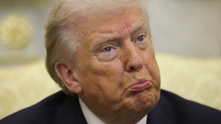 Donald Trump pouts while sitting in the Oval Office
