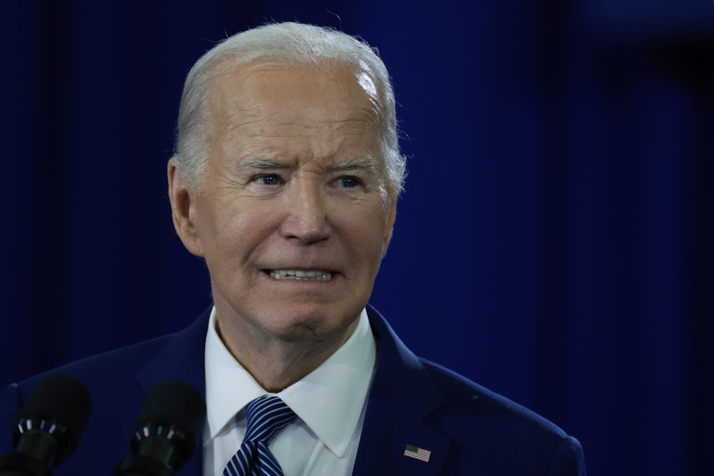Joe Biden grits his teeth while giving a speech.