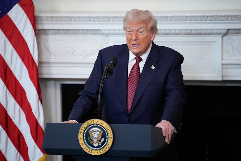 Donald Trump stands at a podium and speaks