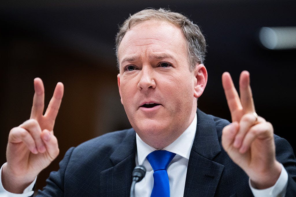 Lee Zeldin holds up two fingers on each hand in an apparent "scare quote" gesture.