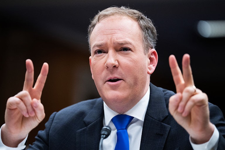 Lee Zeldin holds up two fingers on each hand in an apparent "scare quote" gesture.
