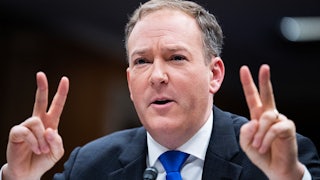 Lee Zeldin holds up two fingers on each hand in an apparent "scare quote" gesture.