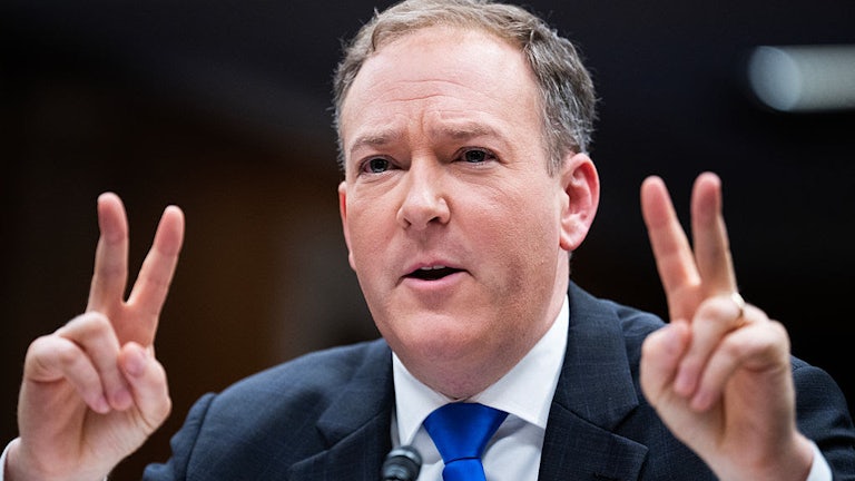 Lee Zeldin holds up two fingers on each hand in an apparent "scare quote" gesture.