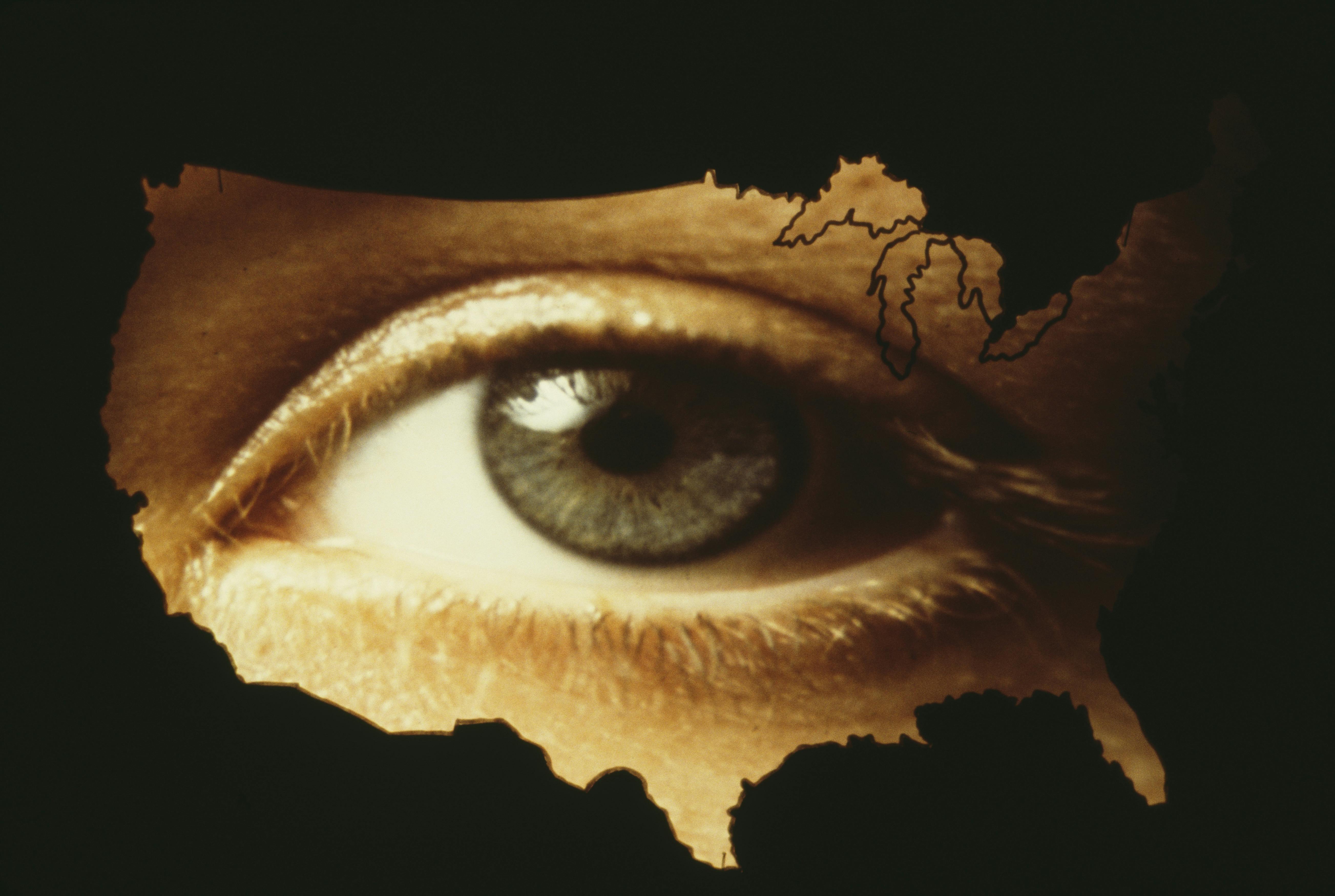 A giant human eye superimposed over a map of the United States mainland