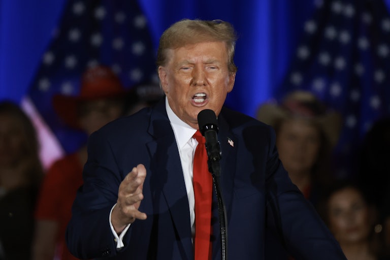 Donald Trump speaks into a microphone