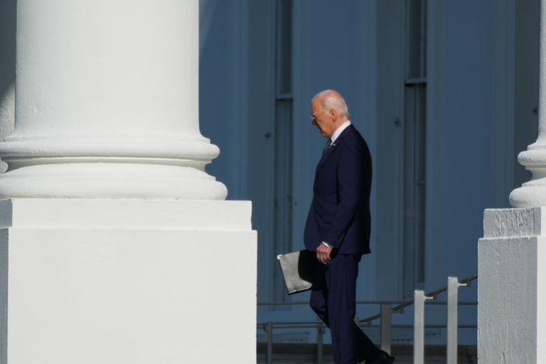 Joe Biden walks out of the White House