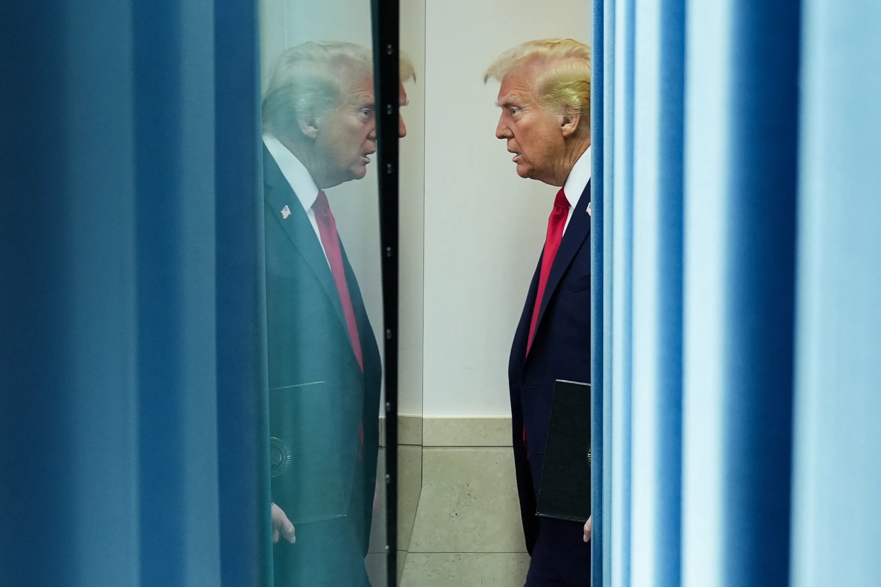 Donald Trump appears in his own reflection.