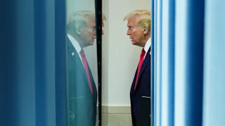Donald Trump appears in his own reflection.