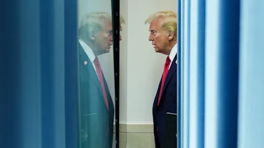 Donald Trump appears in his own reflection.