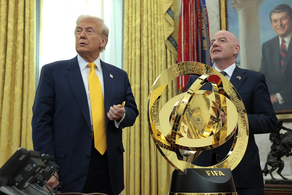 Donald Trump speaks alongside FIFA President Gianni Infantino after unveiling the 2025 Club World Cup trophy in the Oval Office at the White House.