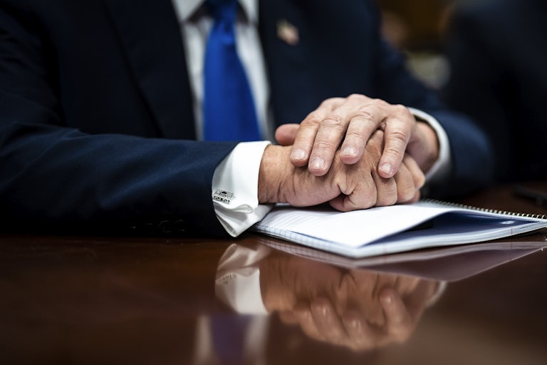 Donald Trump's hands folded on the table
