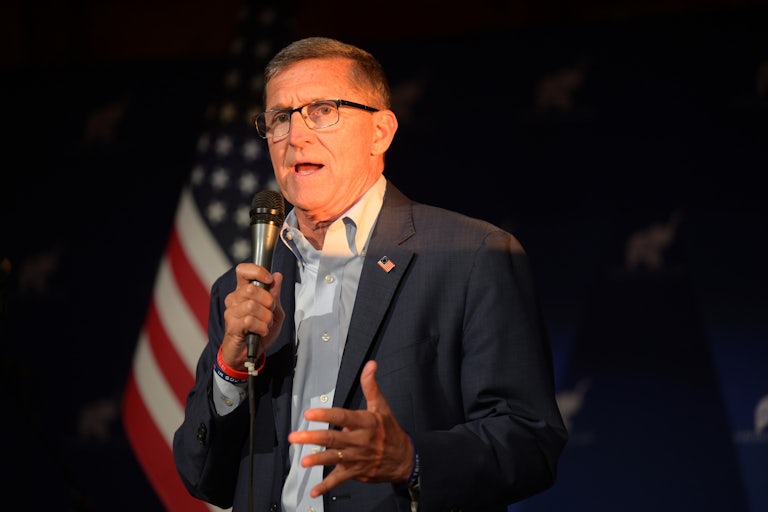 Trump's former national security adviser Michael Flynn speaks with a microphone in his hand