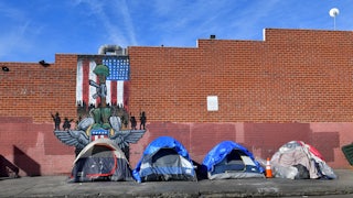 Tents for the homeless line a sidewalk in Los Angeles, California.