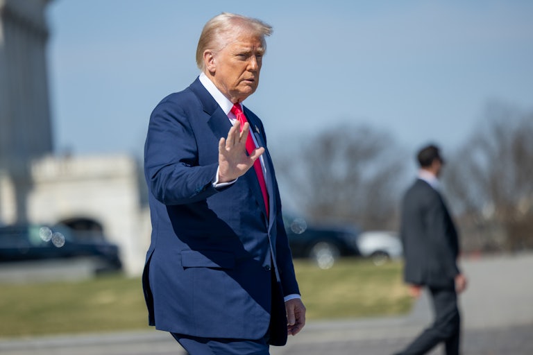 Donald Trump waves while walking outside the Capitol