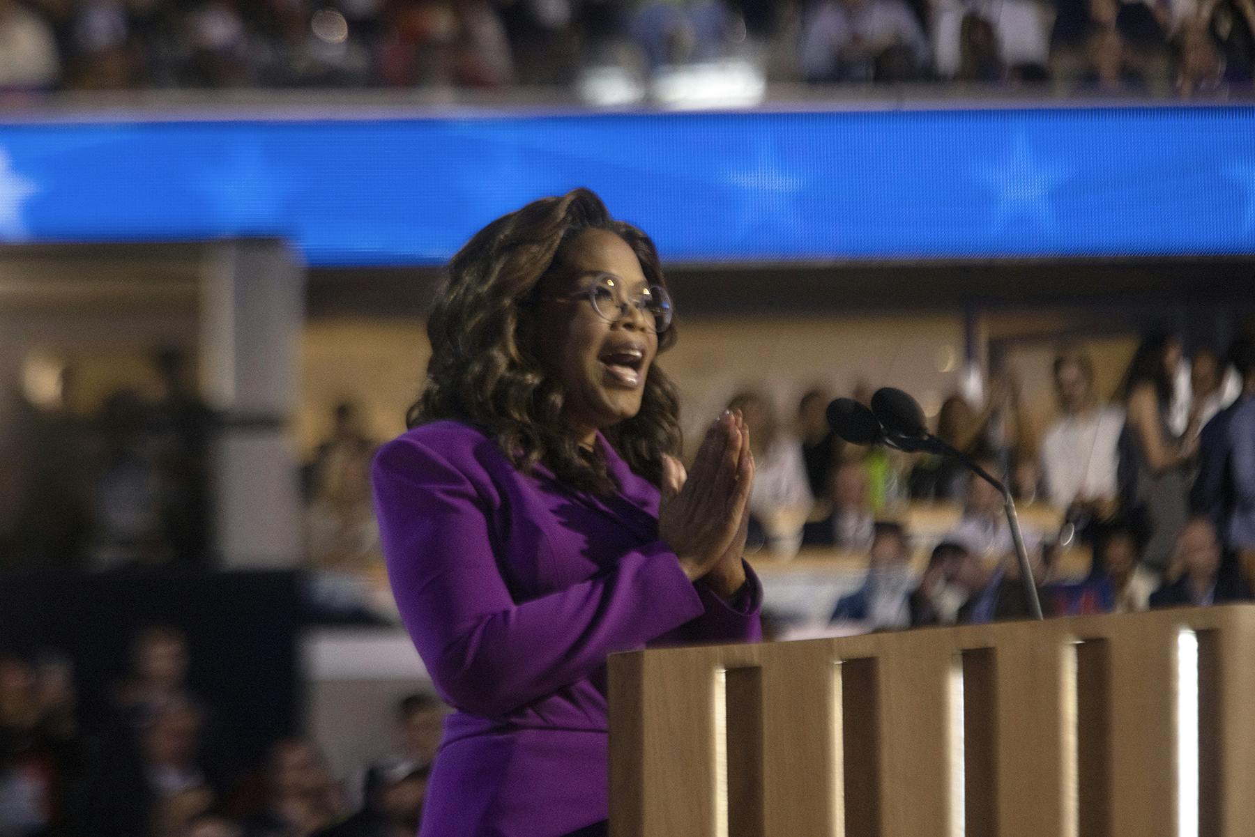 Oprah Winfrey at the podium speaking at the DNC
