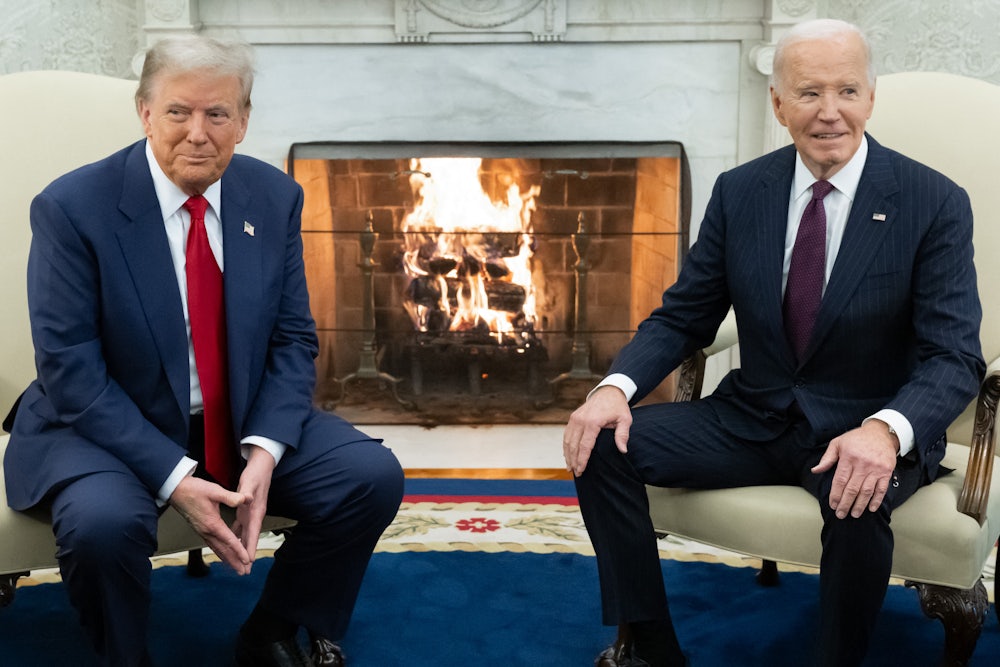 Trump sits to the left of a large fire and Biden sits to the right. Both sit in fancy armchairs.