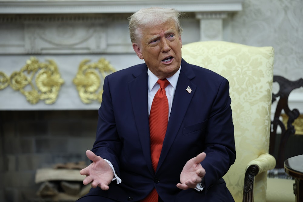 Donald Trump sitting in the Oval Office of the White House