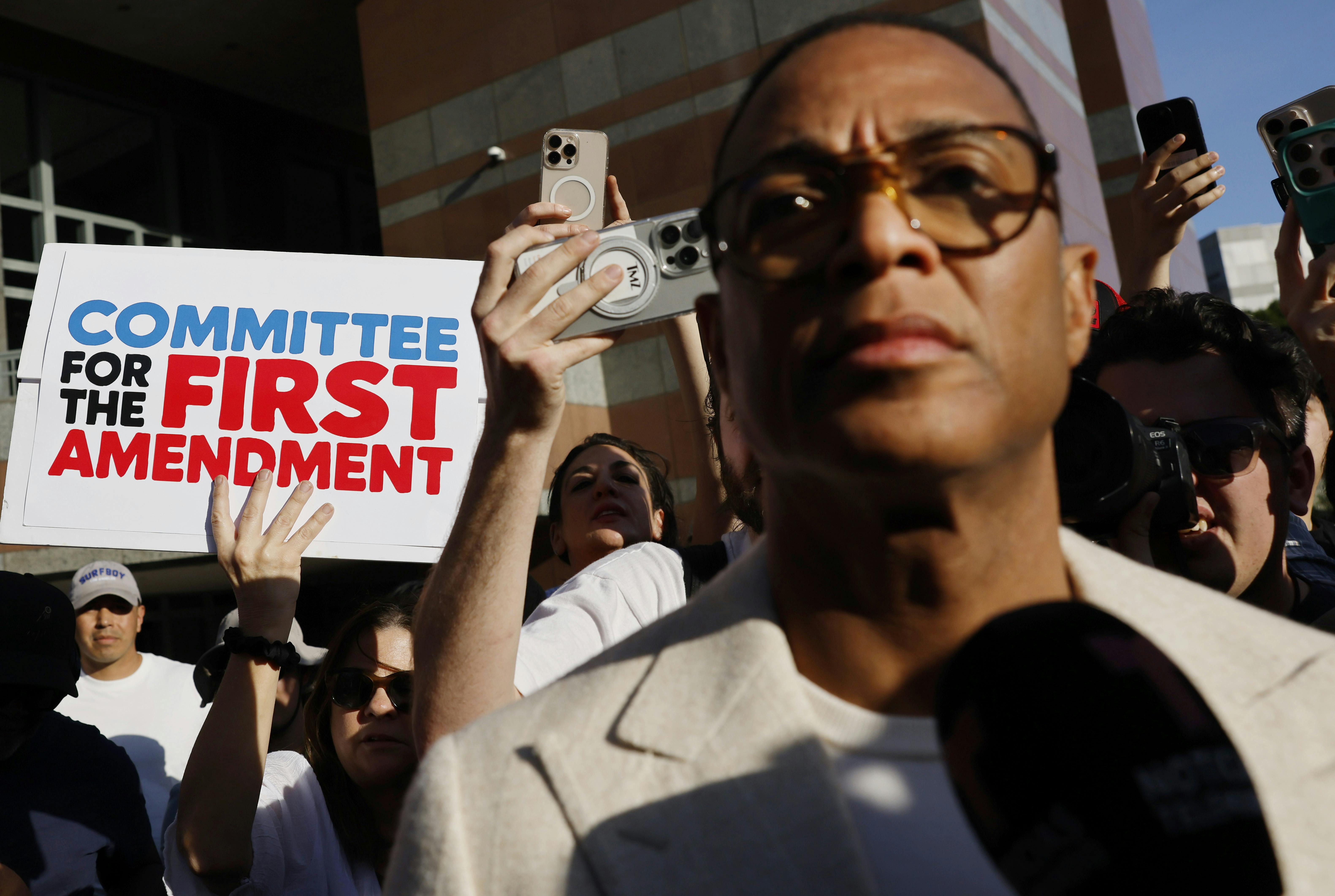 Don Lemon in front of a sign reading Committee for the First Amendment