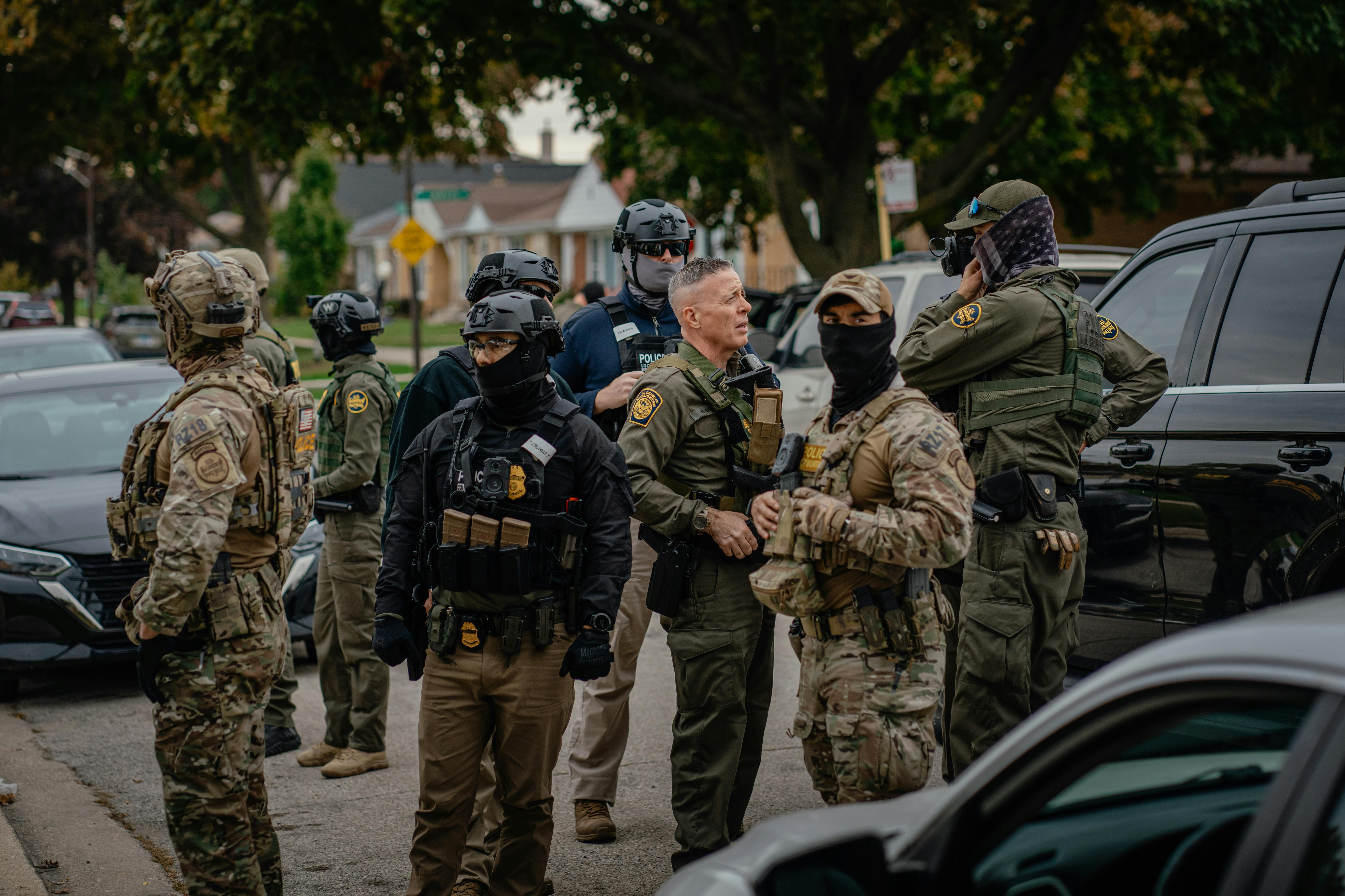 Customs and Border Patrol agents stand in a Chicago neighborhood