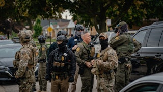 Customs and Border Patrol agents stand in a Chicago neighborhood