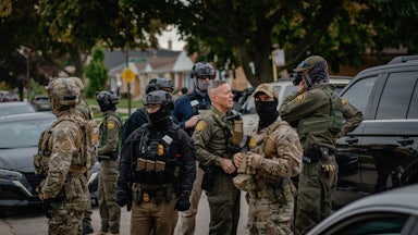 Customs and Border Patrol agents stand in a Chicago neighborhood