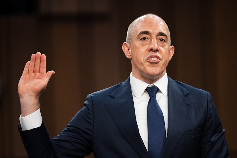 Emil Bove raises his hand while swearing in during a Senate hearing