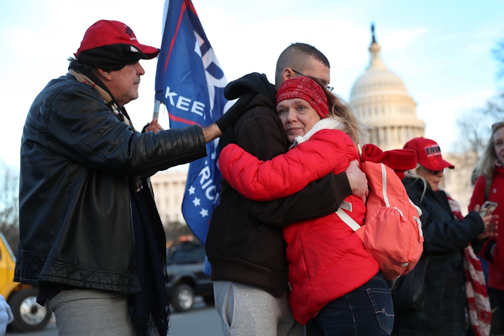 Gary Phaneuf, Tony Naples, and Melody Black visit a memorial for Ashli Babbitt near the U.S. Capitol.